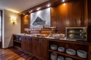 a kitchen with a counter with plates and food at Hotel Fonfreda in Vielha