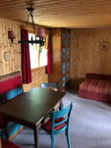 a room with a table and chairs and a bed at Haus am See in Henndorf am Wallersee