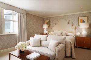 a bedroom with a large bed and a couch at Milestone Hotel Kensington in London