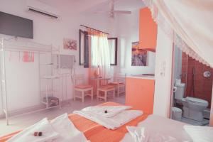 a room with a bed, a chair, and a window at Studio Lefaki in Rethymno