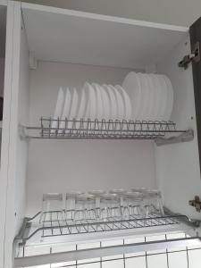 a refrigerator filled with plates and bowls on a shelf at The Sweet Home of Milazzo in Milazzo