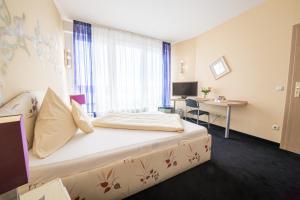 Vuode tai vuoteita majoituspaikassa Europa Hotel Garni