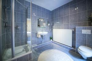 a bathroom with a toilet and a sink and a tub at Europa Hotel Garni free parking in Fürth +43 photos