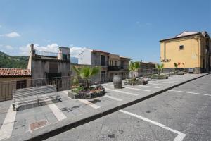 a parking lot with a bench on a city street at Casa Francesca in Castiglione di Sicilia