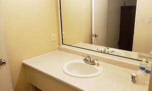 uma casa de banho com um lavatório e um espelho grande em BONITTO INN® Mante em El Mante