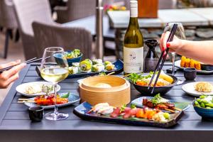 a table with plates of food and a bottle of wine at Lodore Falls Hotel & Spa in Keswick