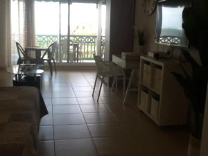 a living room with a couch and a table at Studio 03 vue mer Orient Bay in Orient Bay