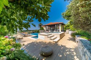 a backyard with a swimming pool and a house at Villa La Vagabonda in Orasac +37 photos