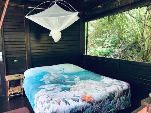 a bed in a room with a window at Serenity Beaches Resort in Uoleva Island