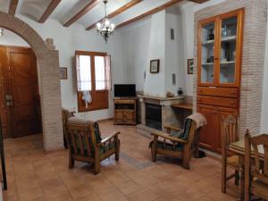 a living room with chairs and a fireplace at Casa Josefina in Yátova