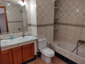 a bathroom with a toilet and a sink and a tub at Casa Josefina in Yátova
