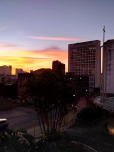 a view of a city skyline with a sunset at Hostel do Lucca in Porto Alegre