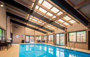 a large indoor pool with skylights and a swimming pool at Tamarack Lodge in Ketchum