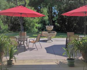 a patio with tables and umbrellas and a fountain at Stahlecker House Inn in Napa