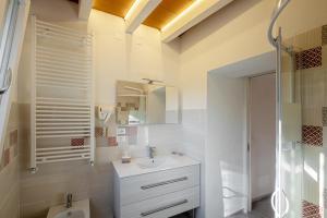 a bathroom with a sink, toilet, and bathtub at La Villa 31 - Rosignano Marittimo - in Rosignano Marittimo