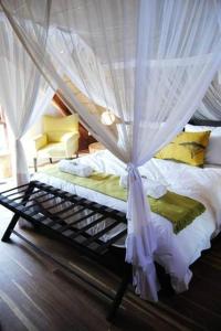 a bedroom with a bed with a mosquito net at Von Bach Dam Resort in Okahandja