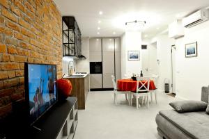 a living room and dining room with a brick wall at ANiMA Zagreb Luxury Apartment in Zagreb