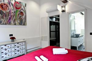 a bedroom with a red bed and a mirror at ANiMA Zagreb Luxury Apartment in Zagreb