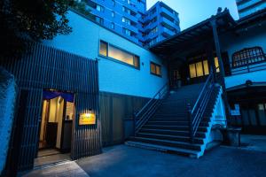 a blue building with stairs in front of a building at 宿坊 正伝寺 Temple hotel Shoden-ji in Tokyo