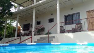 a house with a swimming pool in front of a building at Casa Todo Bueno in Transito