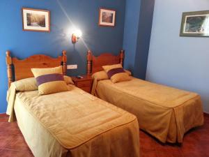 Säng eller sängar i ett rum på Hostal Restaurante Asador Pañart