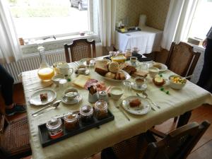 a table with a breakfast of food on it at Bed&Breakfast ons Oda in Sint-Oedenrode