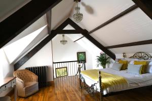 ein Schlafzimmer mit einem großen Bett im Dachgeschoss in der Unterkunft Welch House in Douglas