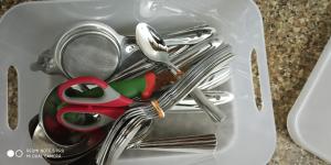 a container with a bunch of utensils in it at Andoor Homes, Apt No 2B in Trivandrum