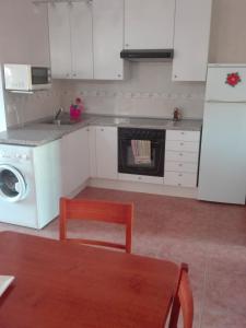 a kitchen with a stove and a dishwasher at turismo rural del somontano (Alquiler de apartamentos) in Salas Bajas