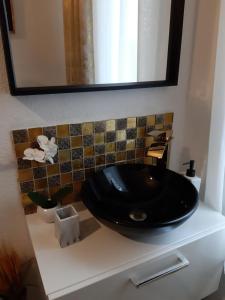 um lavatório preto num balcão na casa de banho em Room Lux SPA " TABARKA " em Spa