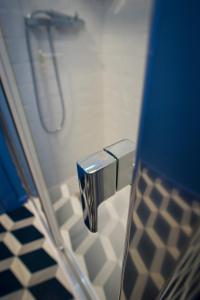 a bathroom with a shower stall with a toilet at ZIGZAG HOSTEL in Praia da Vitória