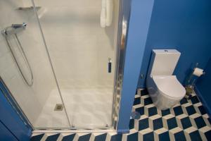 a bathroom with a shower stall with a toilet at ZIGZAG HOSTEL in Praia da Vitória