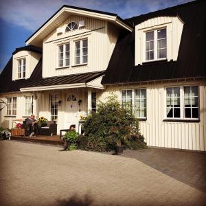 a large white house with a black roof at The White House in Reykholt