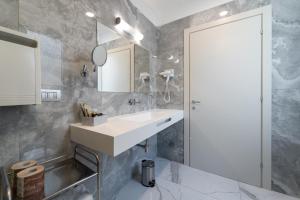 a bathroom with a white sink and a mirror at Hotel Milano Castello in Milan