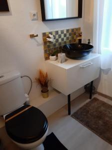 a bathroom with a black sink and a toilet at Room Lux SPA " TABARKA " in Spa