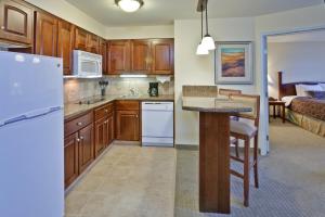 a kitchen with wooden cabinets and a island in a room at Staybridge Suites Indianapolis-Carmel by IHG in Carmel +18 photos