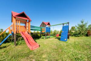 a group of childrens playground equipment in a field at Domki u Beaty in Rewal