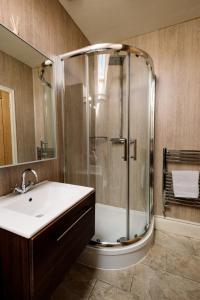 a bathroom with a shower and a sink at The Rectory Rooms, Studio 3 in Skipton