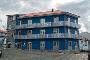a blue building with a white balcony at ZIGZAG HOSTEL in Praia da Vitória