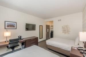 a hotel room with a bed and a desk with a computer at Ohio House Motel in Chicago