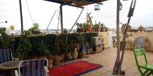 a balcony with potted plants and a table and chairs at dar said in Rabat