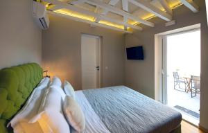 a bedroom with a bed and a large window at Metis Athens Suites in Athens