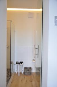 a bathroom with a table and a glass door at Six! Eat Work Sleep in Brühl