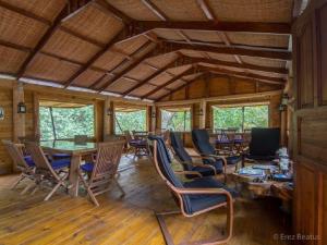 a dining room with chairs and tables in a cabin at Serenity Beaches Resort in Uoleva Island