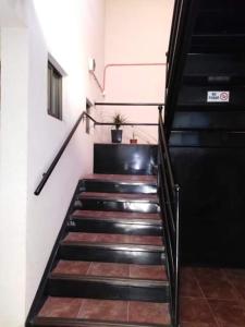 a staircase in a building with black and wooden floors at Hotel Eclipse in Concepción