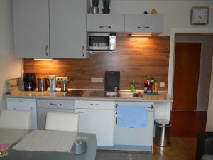 a kitchen with white cabinets and a sink at Ferienwohnung Villa Lütt in Bleckede