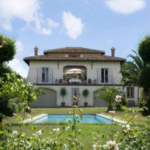 a large house with a pool in front of it at Villa Romana in Campagnano di Roma