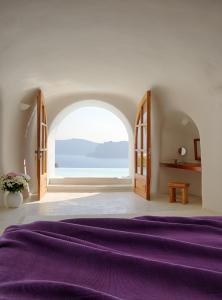 A bed or beds in a room at Perivolas Hotel