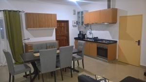 a kitchen and dining room with a table and chairs at Ibex Heights in Lusaka