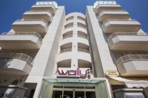 a tall building with a wii sign on it at Wally Residence in Rimini